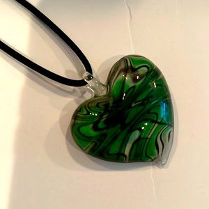 Clear green black glass heart approx 2 in charm connected to a black cord 18 in